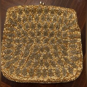 Used small clutch bag/ purse in gold color. Snap top. Made in Hong Kong.